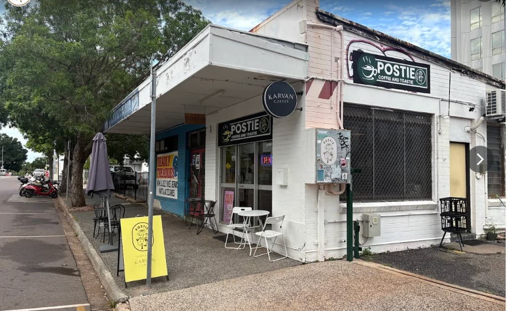 Postie Coffee and Toastie storefront with white brick walls and black signage